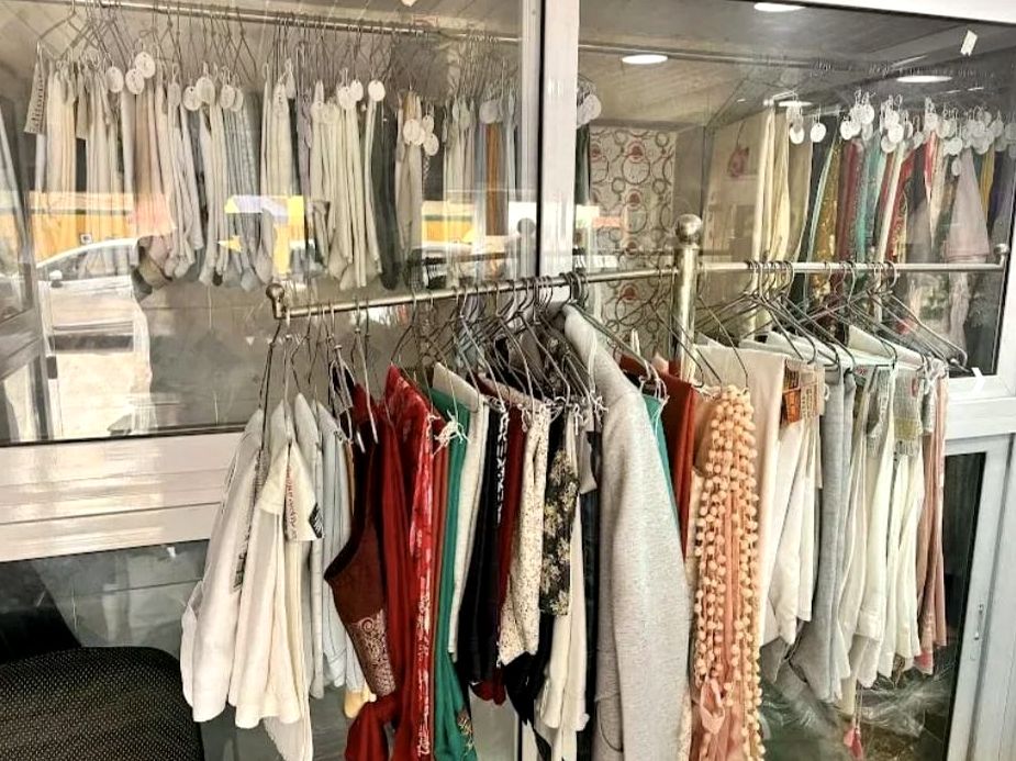 Dry cleaned clothes, tagged and hung on the rail at our Janakpuri shop