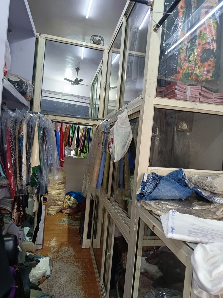 Glass cabinets of cleaned clothes inside Balaji Dry Cleaners