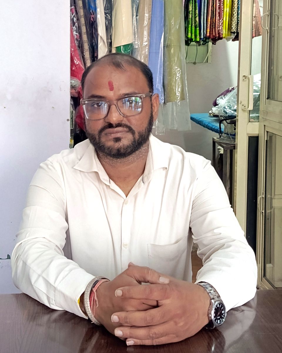 The owner of Balaji Dry Cleaners at the counter of our Janakpuri shop