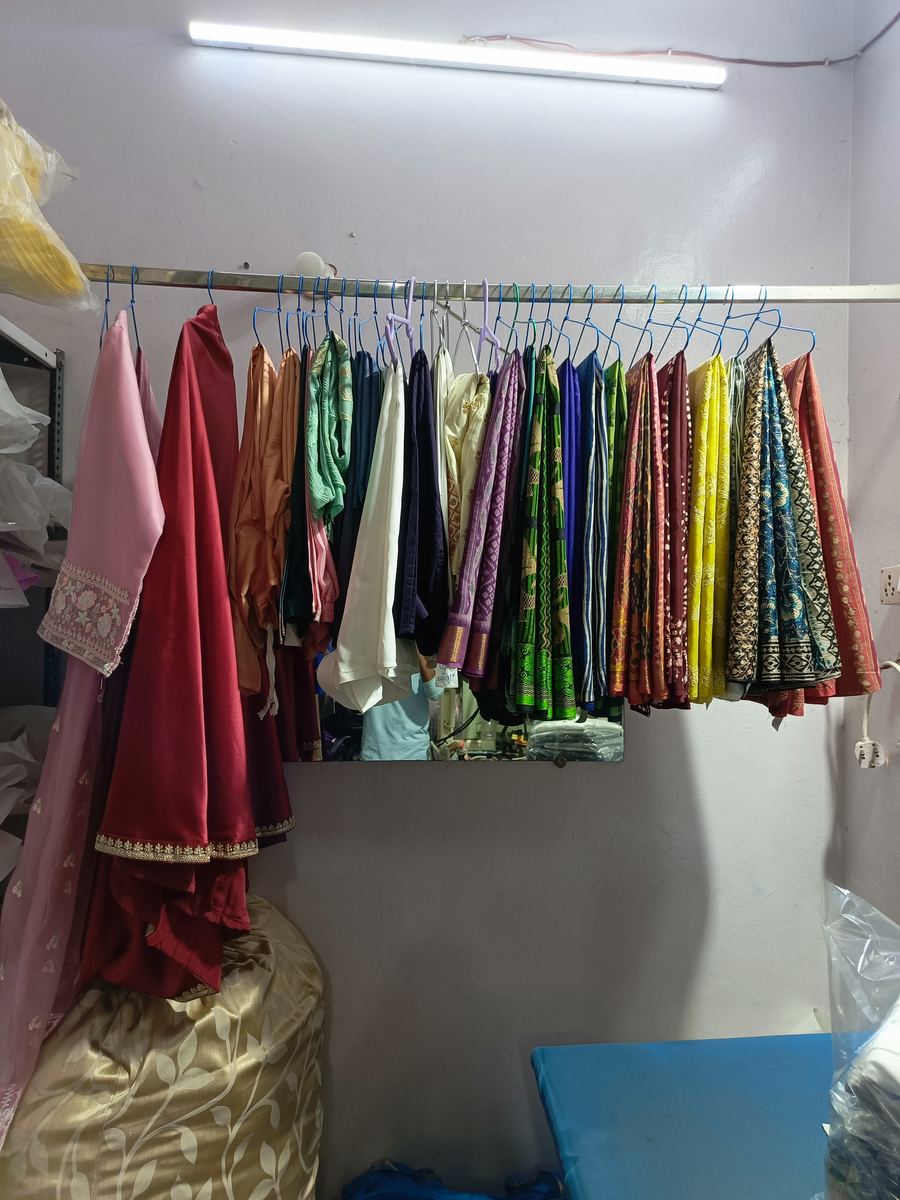 Sarees and suits hanging after dry cleaning